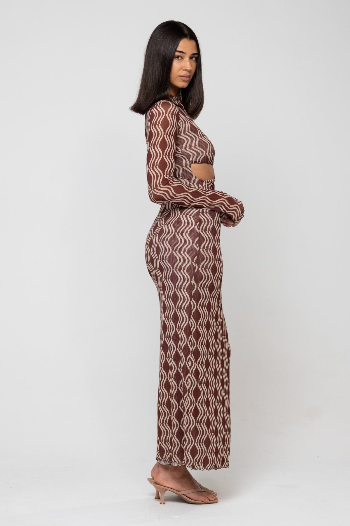 This is an image of Audrey Dress in Coco - RESA featuring a model wearing the dress