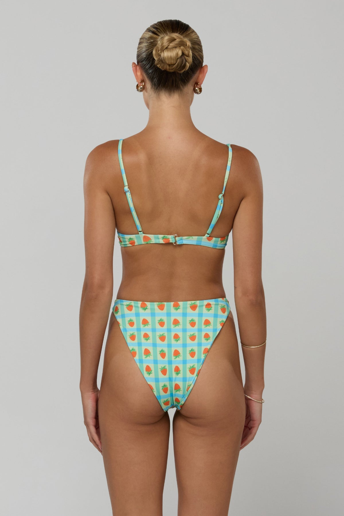 This is an image of Betsy Bikini Bottom in Juicy - RESA featuring a model wearing the dress