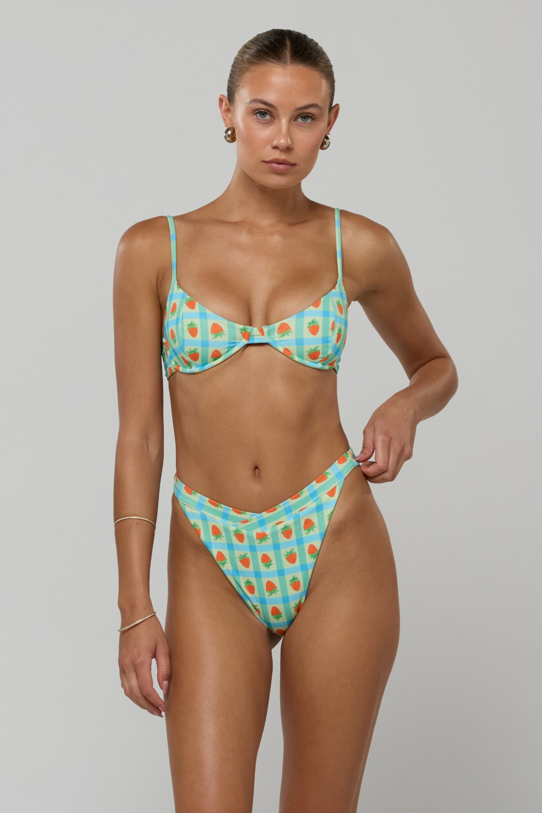 This is an image of Betsy Bikini Bottom in Juicy - RESA featuring a model wearing the dress