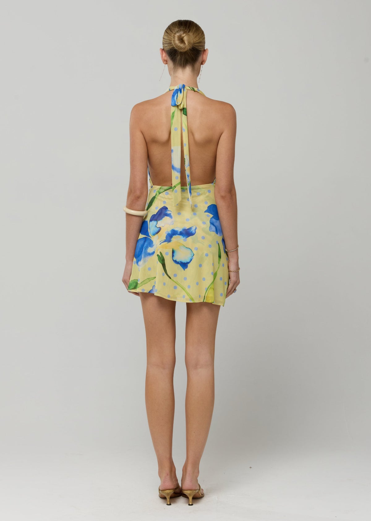 This is an image of Bruna mini in Solei - RESA featuring a model wearing the dress
