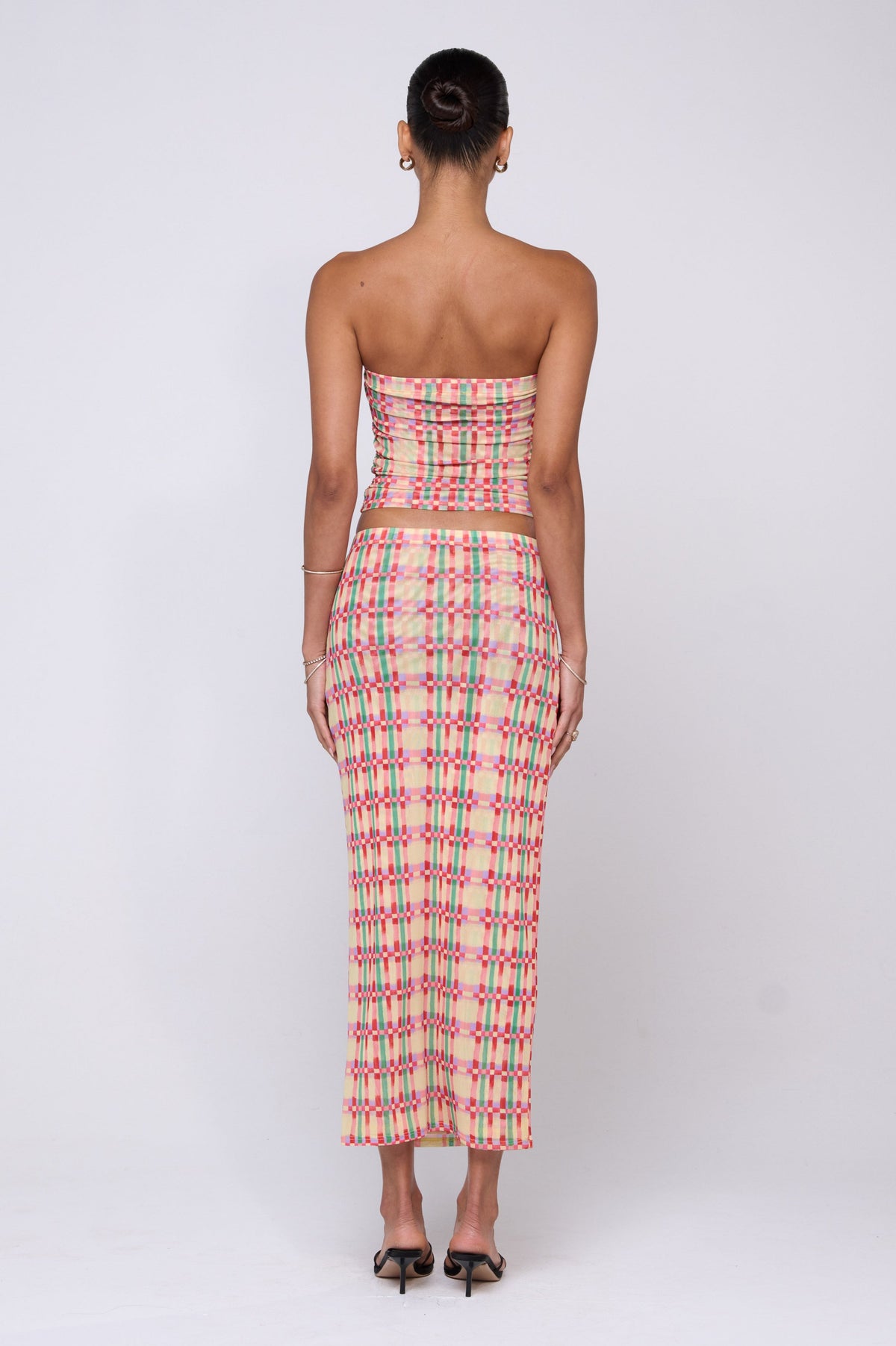 This is an image of Clyde Mesh Skirt in Plaid - RESA featuring a model wearing the dress