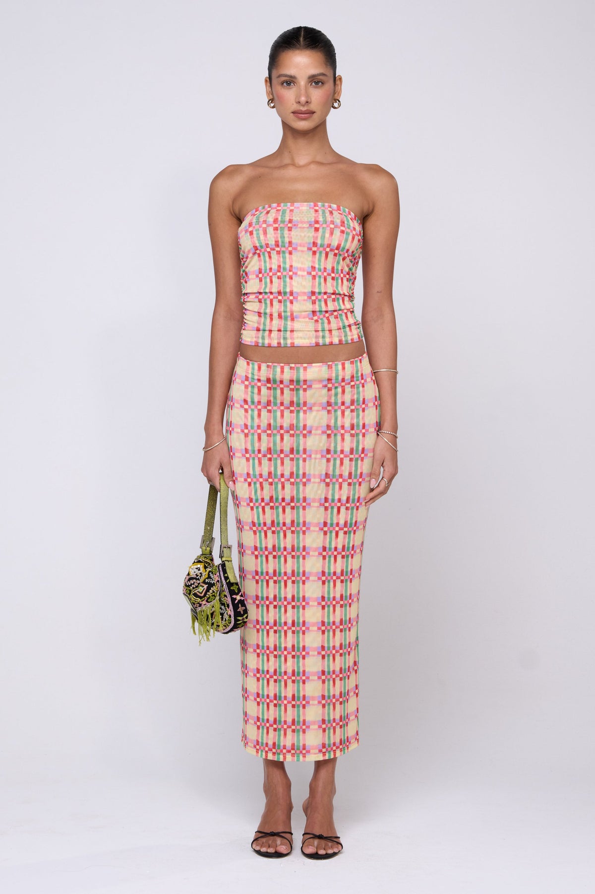 This is an image of Clyde Mesh Skirt in Plaid - RESA featuring a model wearing the dress