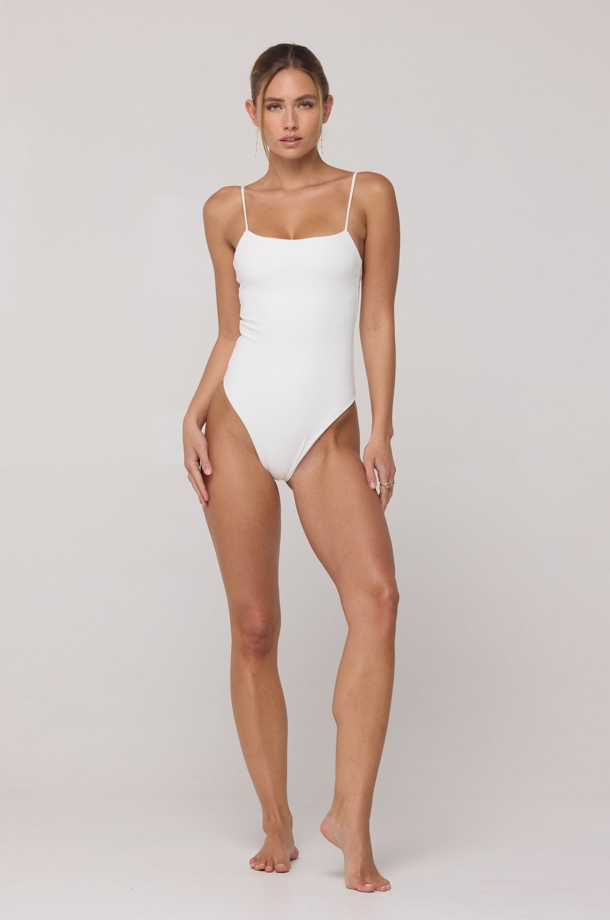 This is an image of Dominick One Piece Swimsuit in White - RESA featuring a model wearing the dress