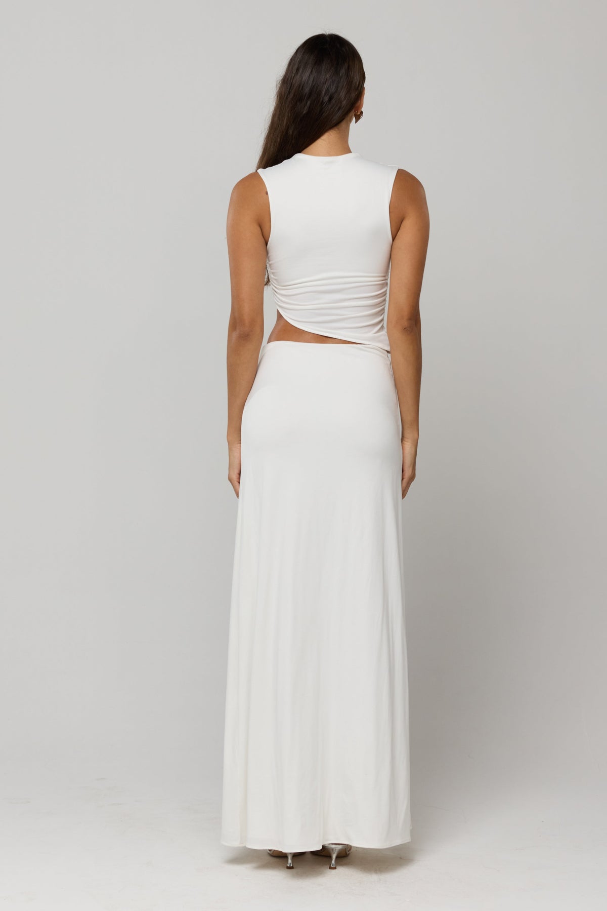 This is an image of Estelle Skirt in White Knit - RESA featuring a model wearing the dress