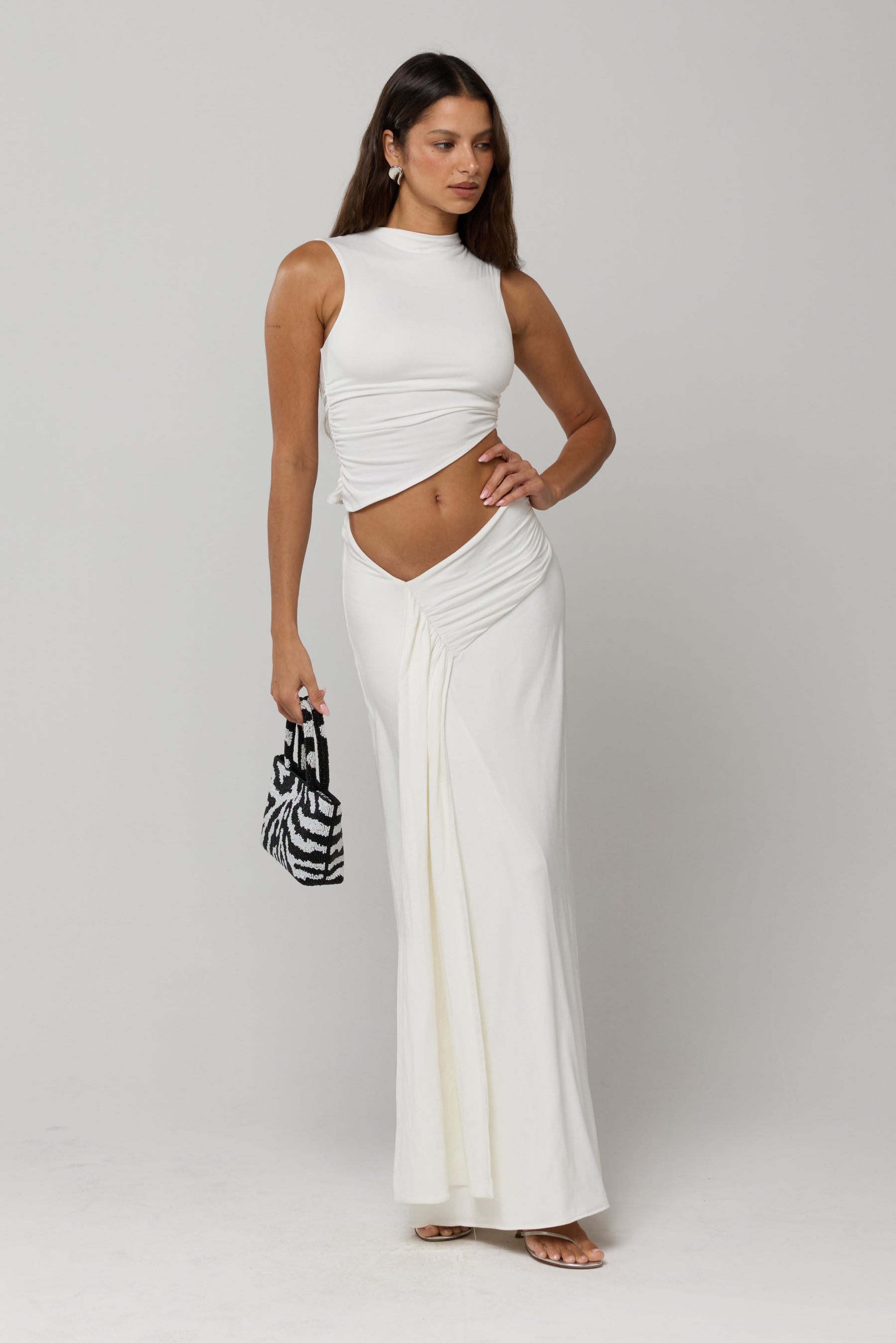 This is an image of Estelle Skirt in White Knit - RESA featuring a model wearing the dress
