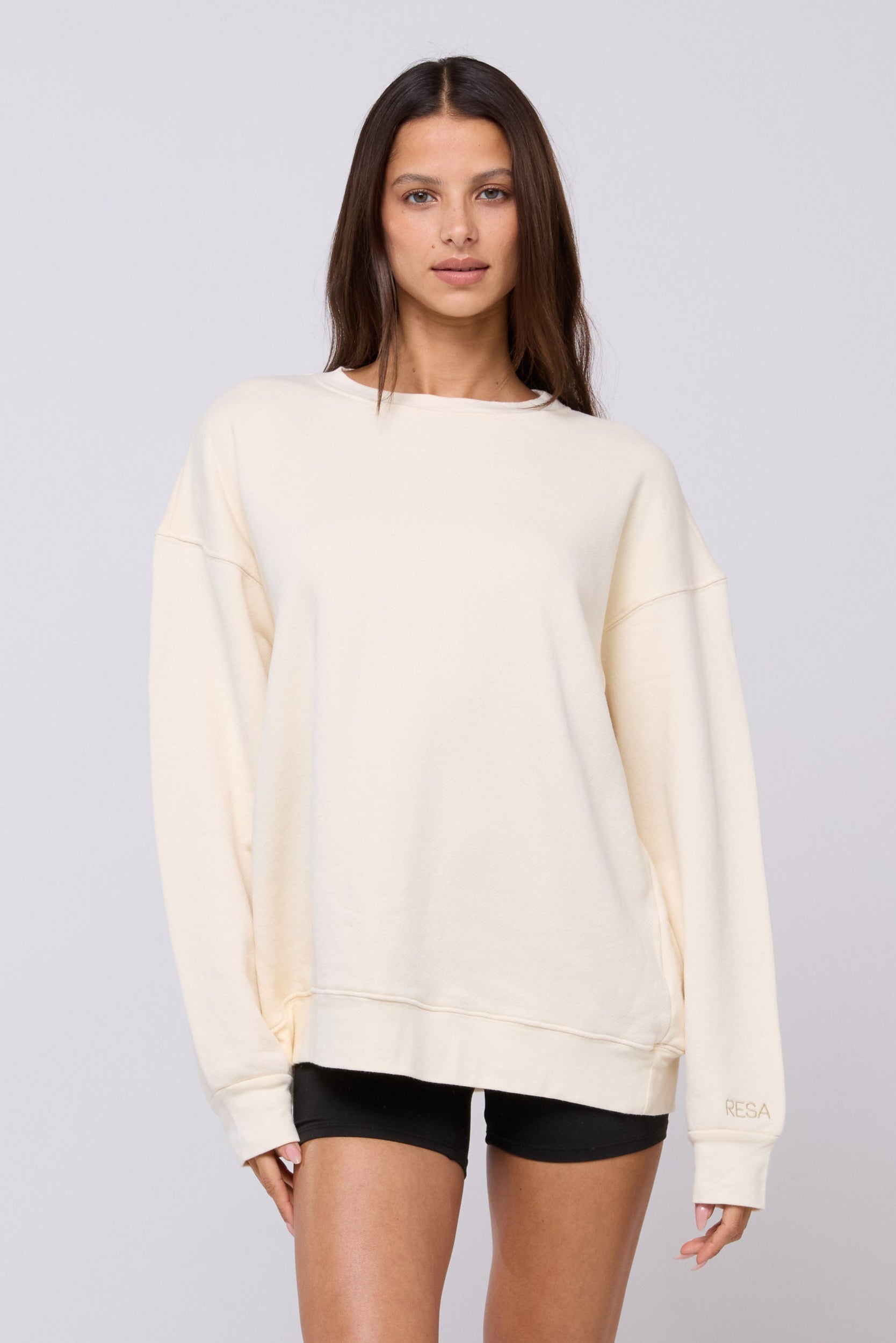 This is an image of Gunner Sweatshirt in Bone - RESA featuring a model wearing the dress