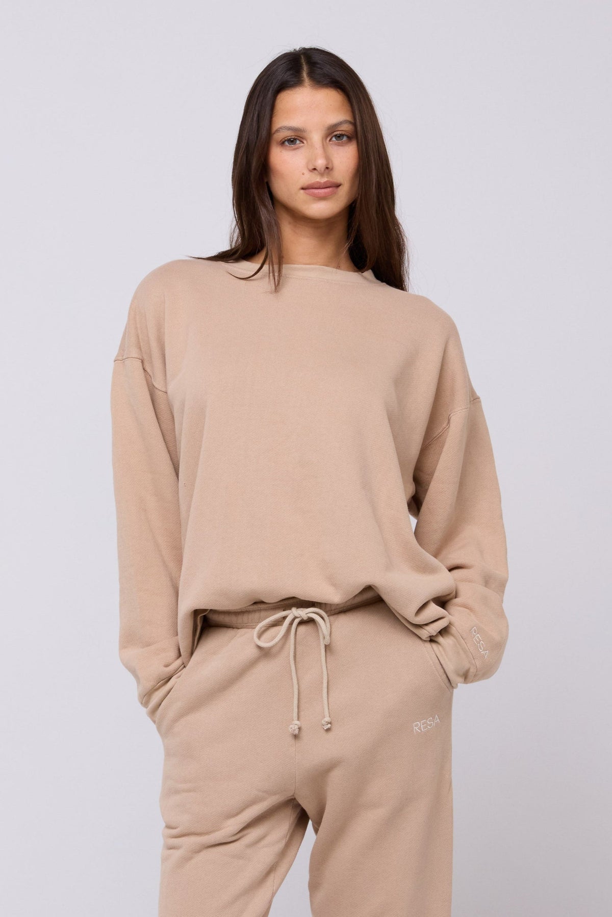 This is an image of Gunner Sweatshirt in Sand - RESA featuring a model wearing the dress