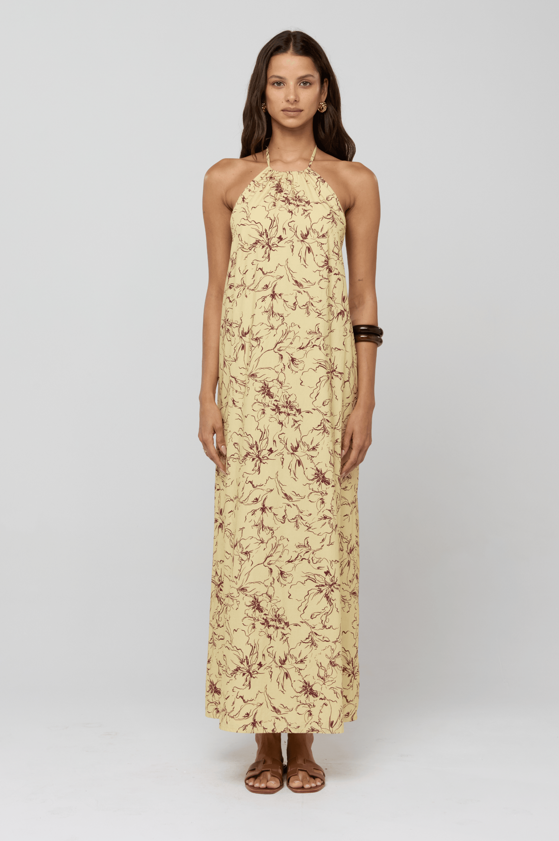This is an image of Iris Halter Dress in Butterscotch - RESA featuring a model wearing the dress