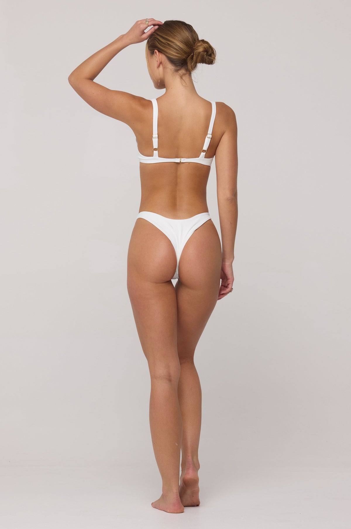 This is an image of Joey Bikini Bottom in White - RESA featuring a model wearing the dress