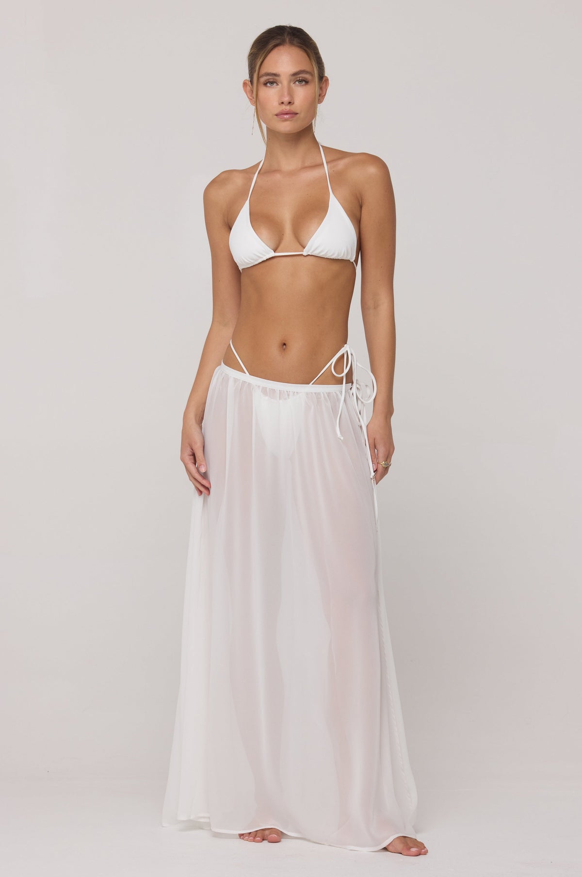 This is an image of Kyle Triangle Bikini Top in White - RESA featuring a model wearing the dress