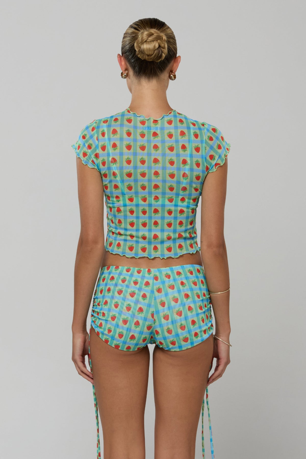 This is an image of Lina Short in Juicy - RESA featuring a model wearing the dress