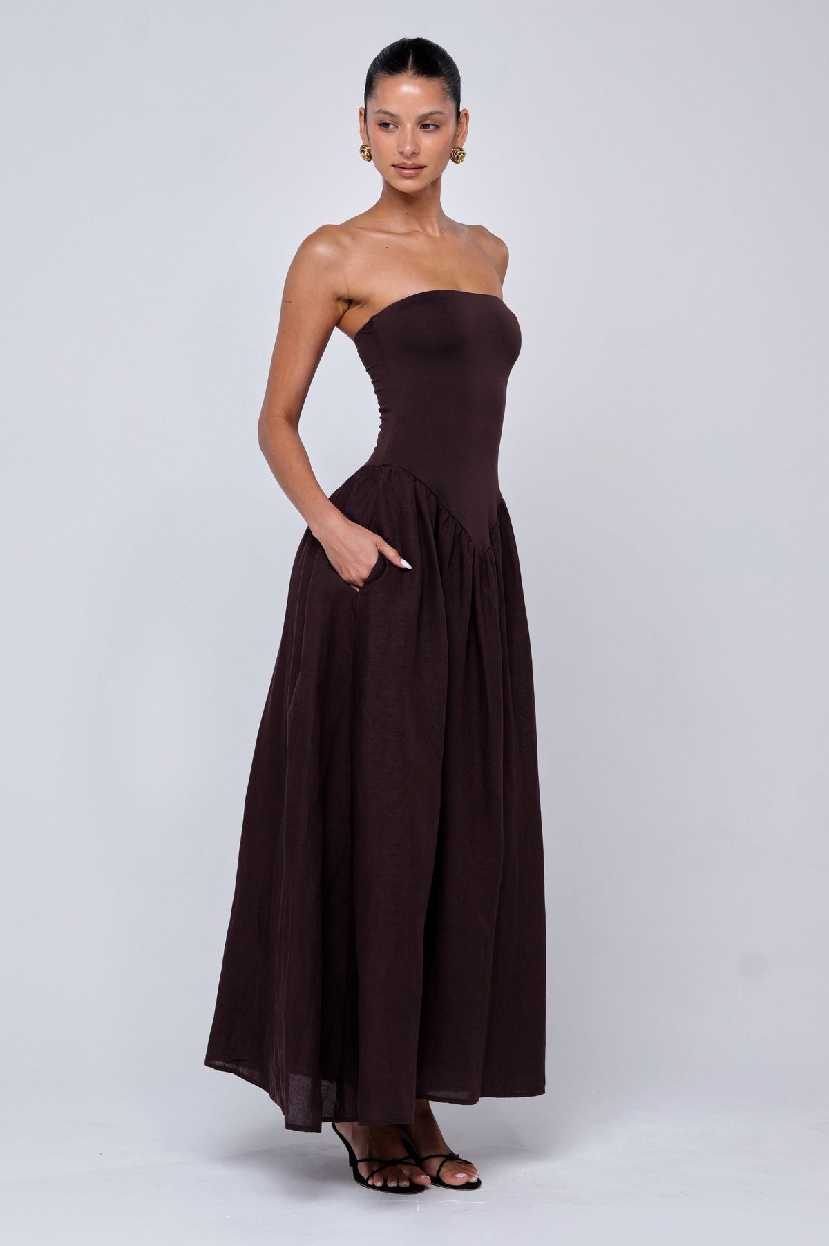 This is an image of Mackenzie Dress in Brown Linen - RESA featuring a model wearing the dress