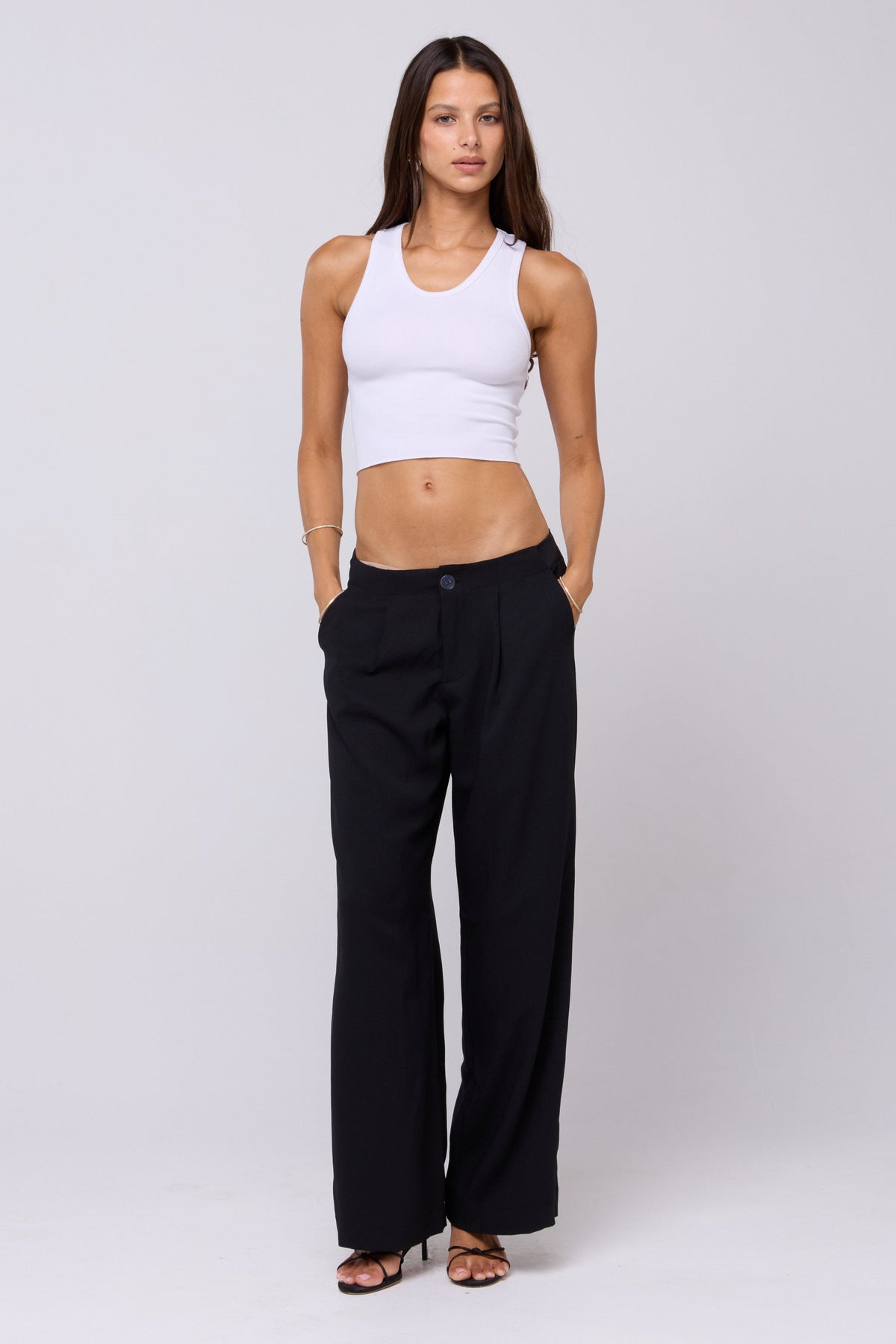 This is an image of Malcolm Trousers in Black - RESA featuring a model wearing the dress