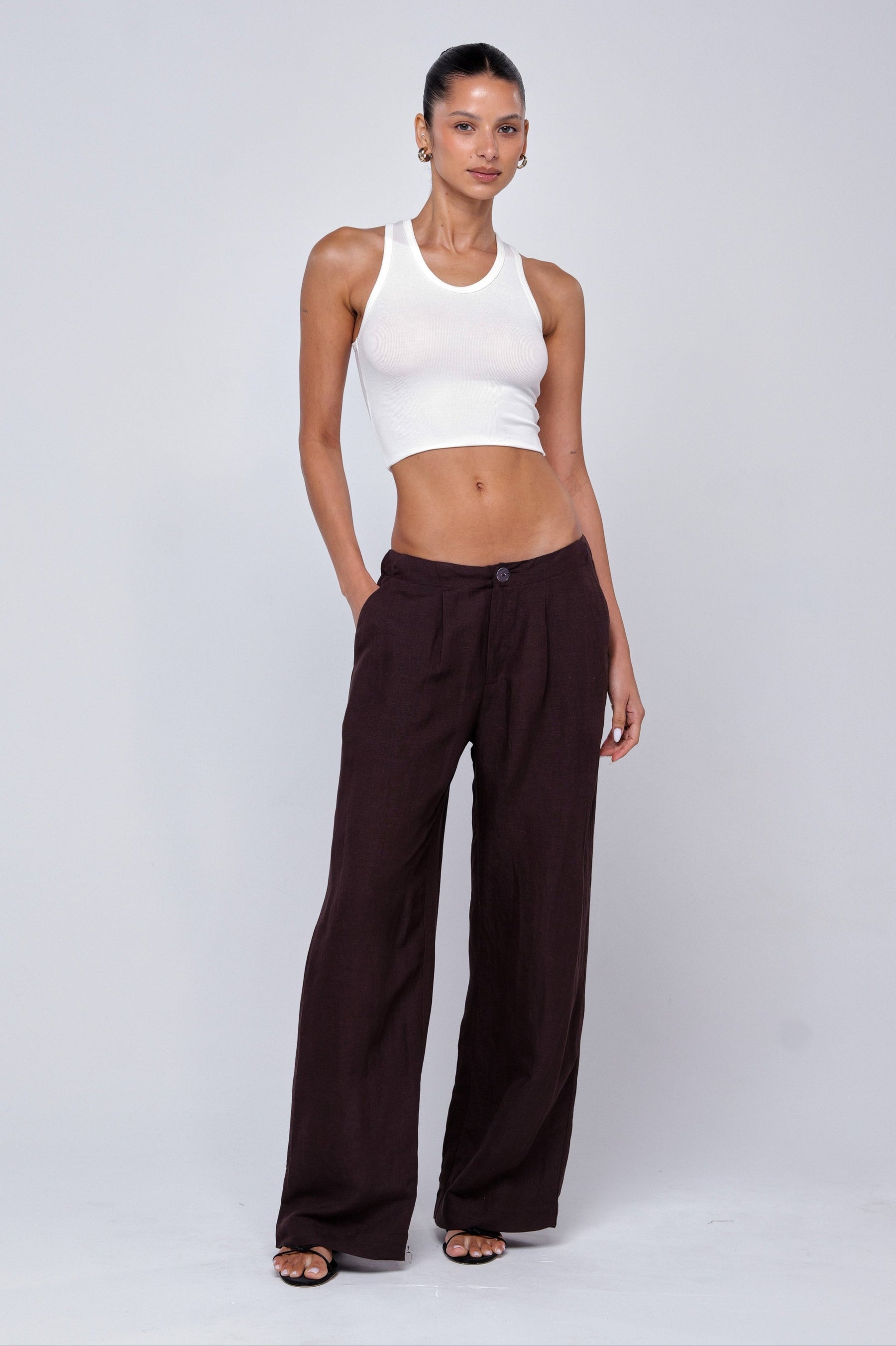 This is an image of Malcolm Trousers in Brown Linen - RESA featuring a model wearing the dress