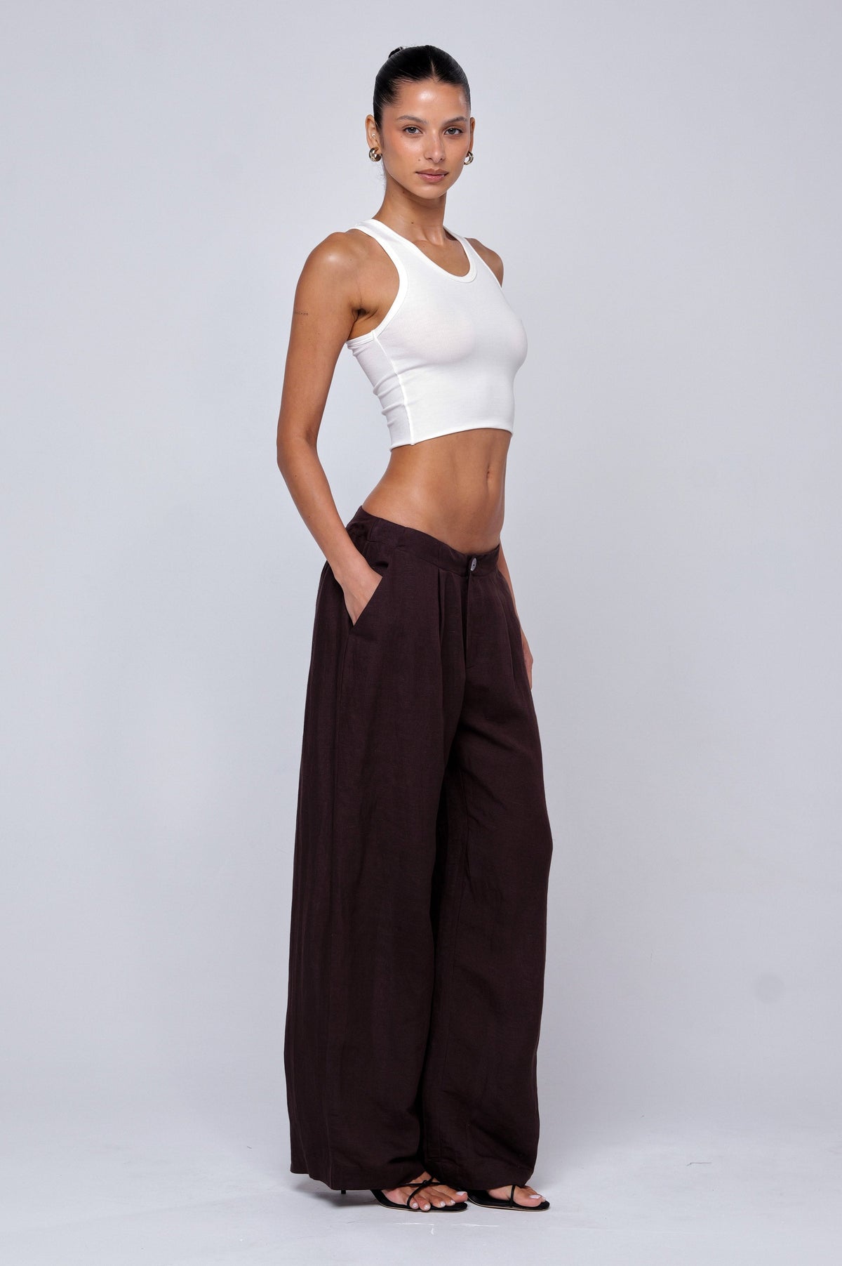 This is an image of Malcolm Trousers in Brown Linen - RESA featuring a model wearing the dress