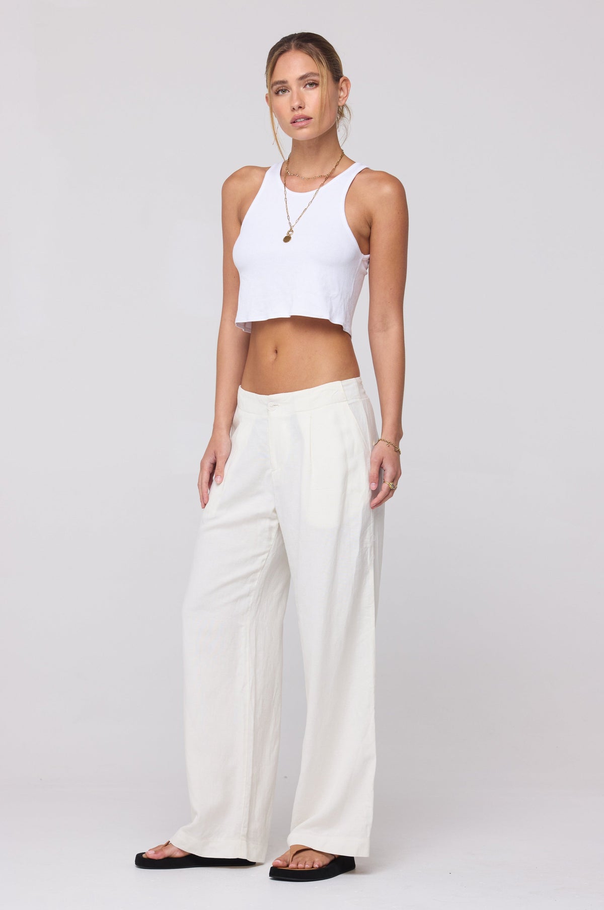 This is an image of Malcolm Trousers in White Linen - RESA featuring a model wearing the dress