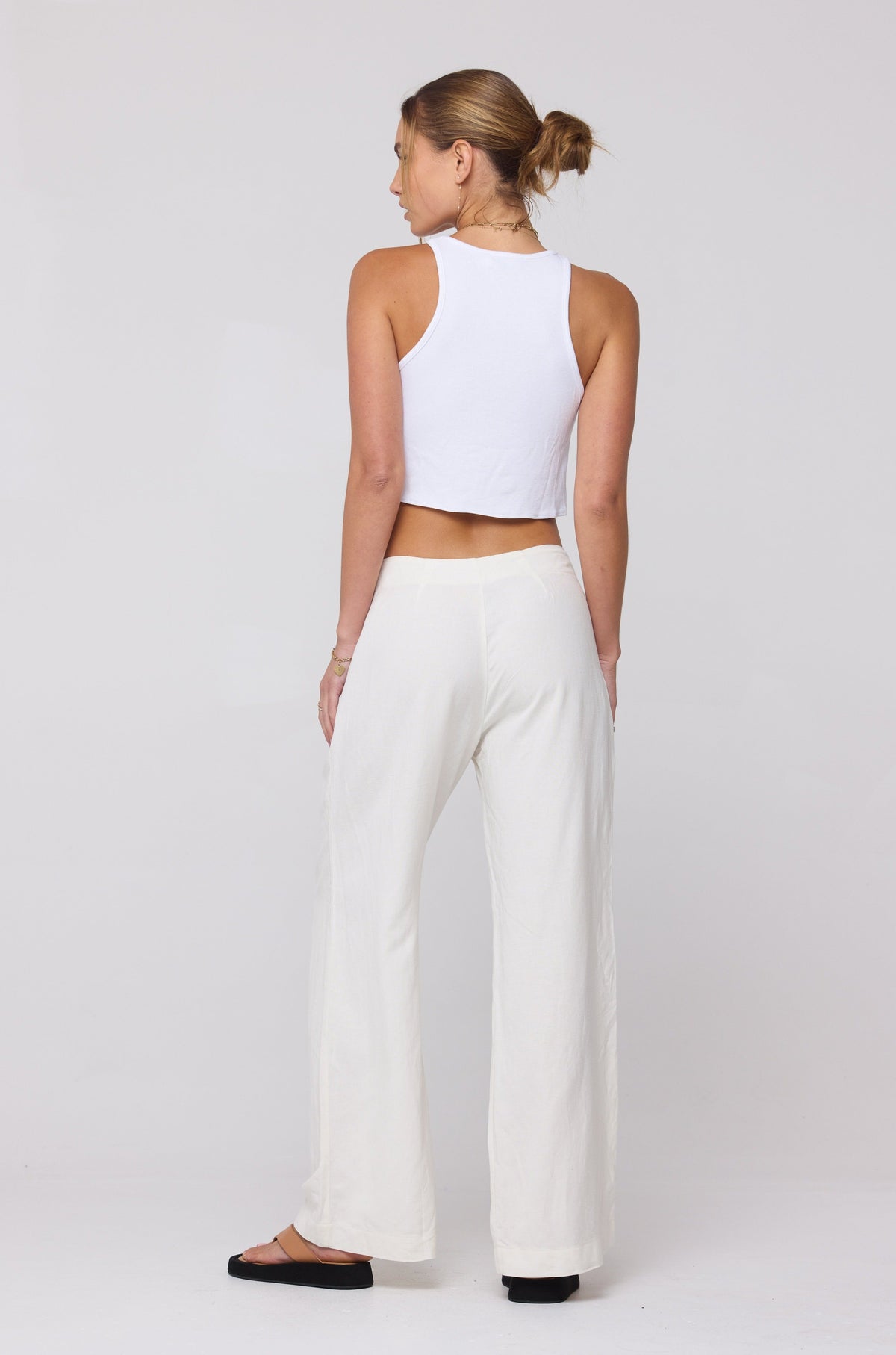 This is an image of Malcolm Trousers in White Linen - RESA featuring a model wearing the dress