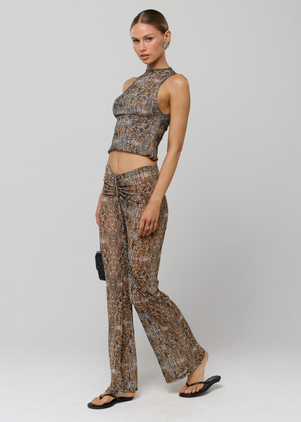 This is an image of Mallory Pant in Serpent - RESA featuring a model wearing the dress