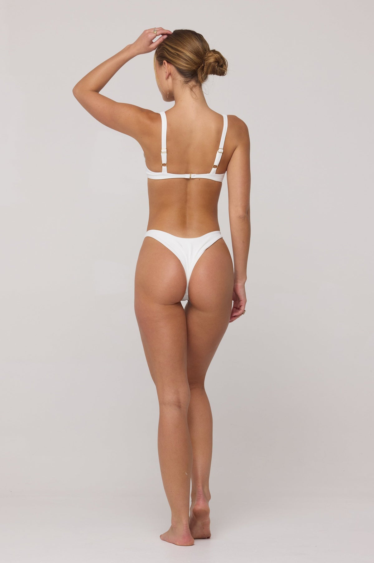 This is an image of Matty Bikini Top in White - RESA featuring a model wearing the dress