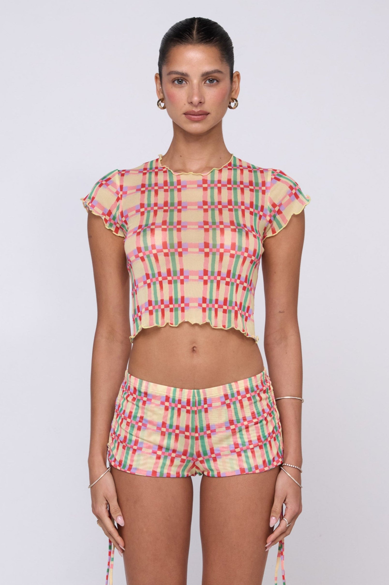 This is an image of Micro Shorts in Plaid - RESA featuring a model wearing the dress