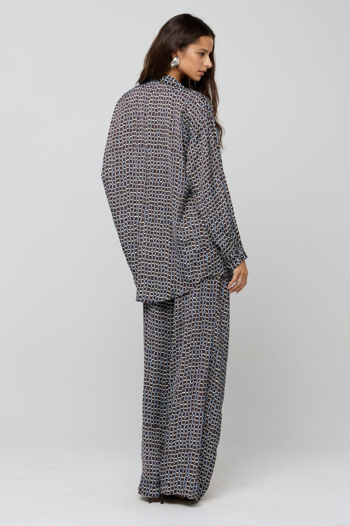 This is an image of Monica Blouse in Tide - RESA featuring a model wearing the dress