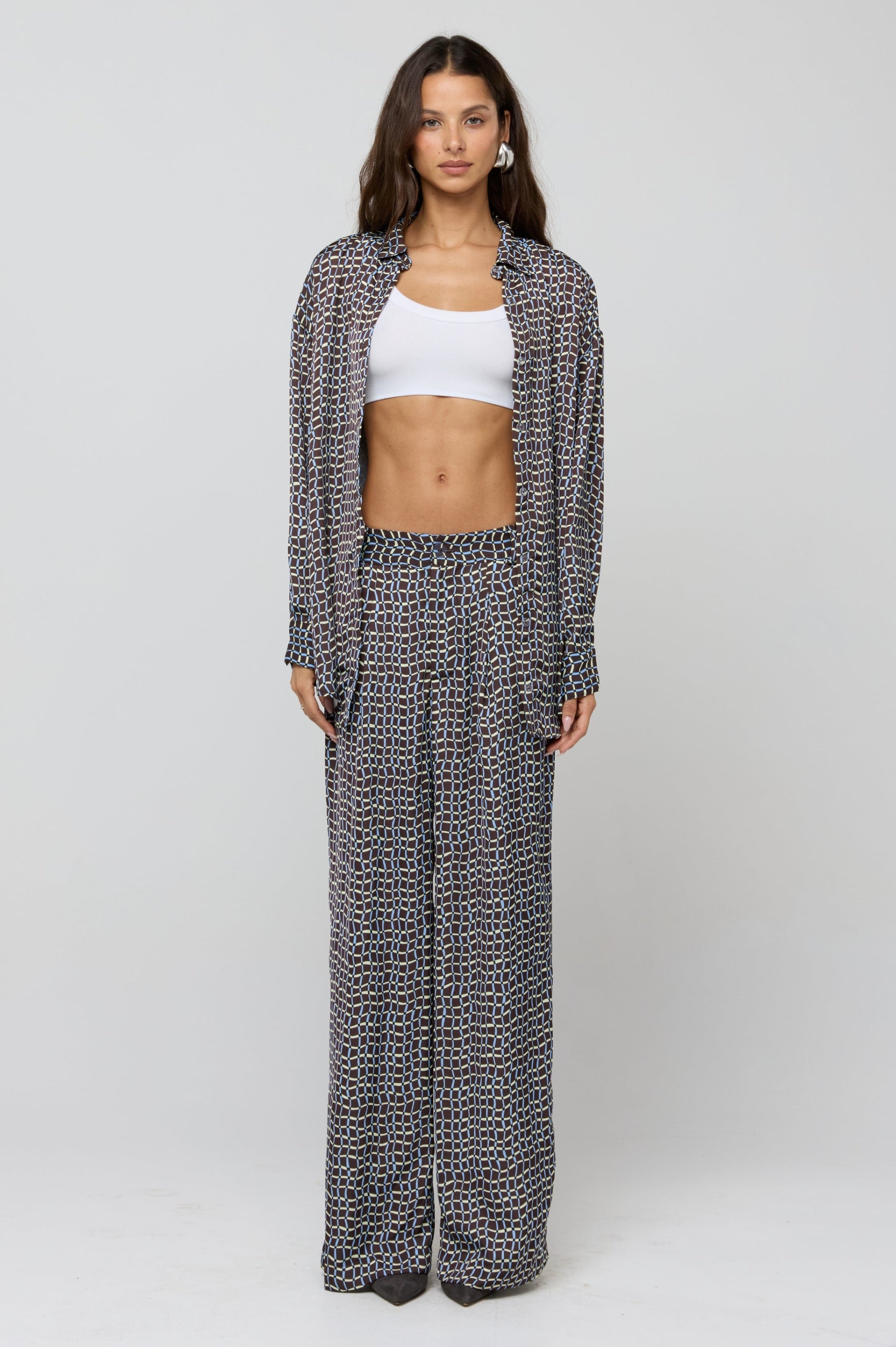 This is an image of Monica Blouse in Tide - RESA featuring a model wearing the dress