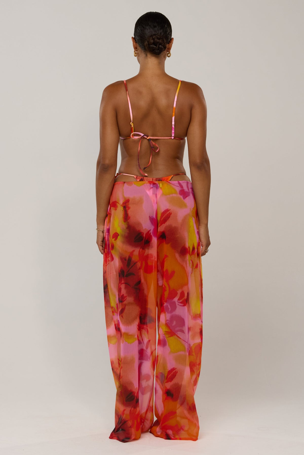 This is an image of Raye Pant in Lilikoi - RESA featuring a model wearing the dress