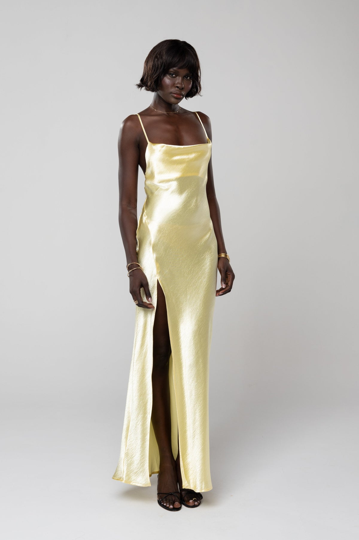 This is an image of River Slip in Butter - RESA featuring a model wearing the dress