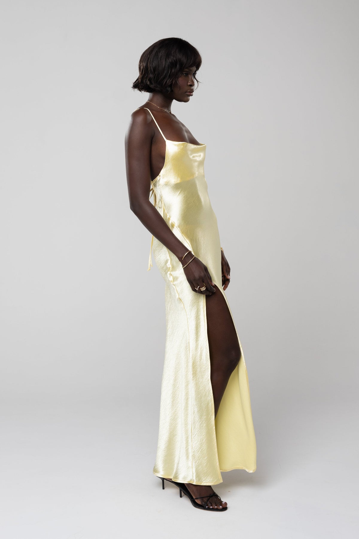 This is an image of River Slip in Butter - RESA featuring a model wearing the dress