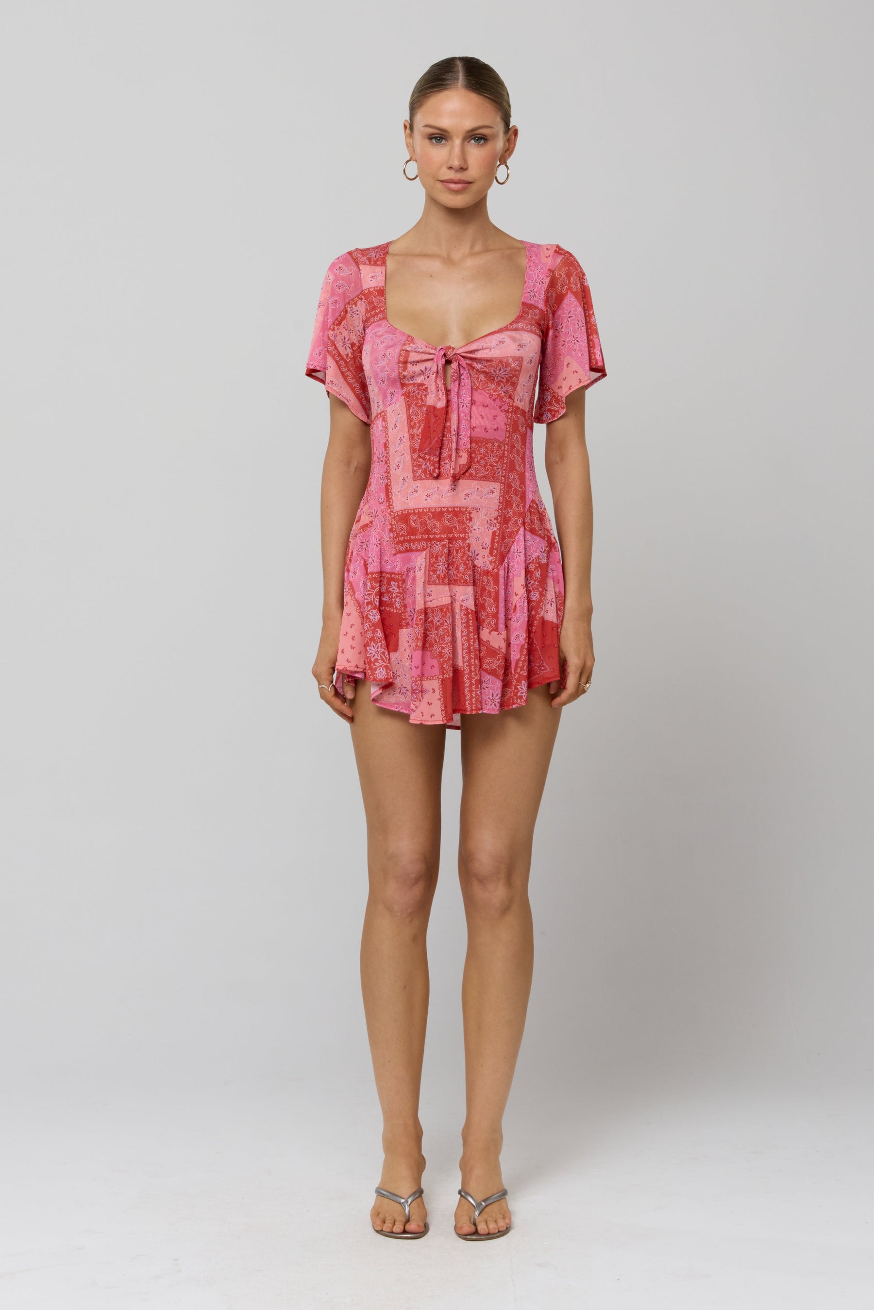 This is an image of Romy Romper in Patsy - RESA featuring a model wearing the dress