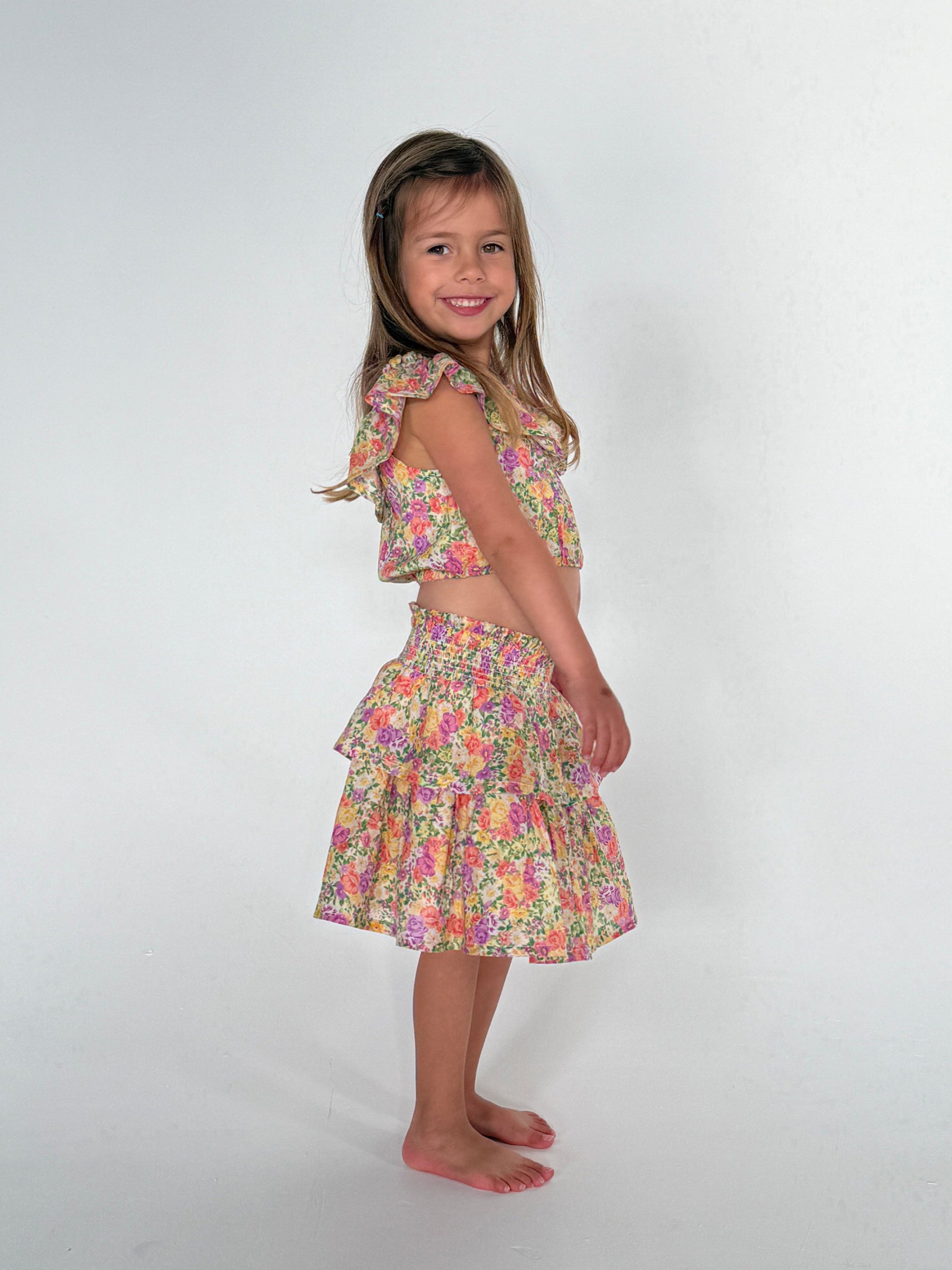 This is an image of Stella Kids Set in April - RESA featuring a model wearing the dress