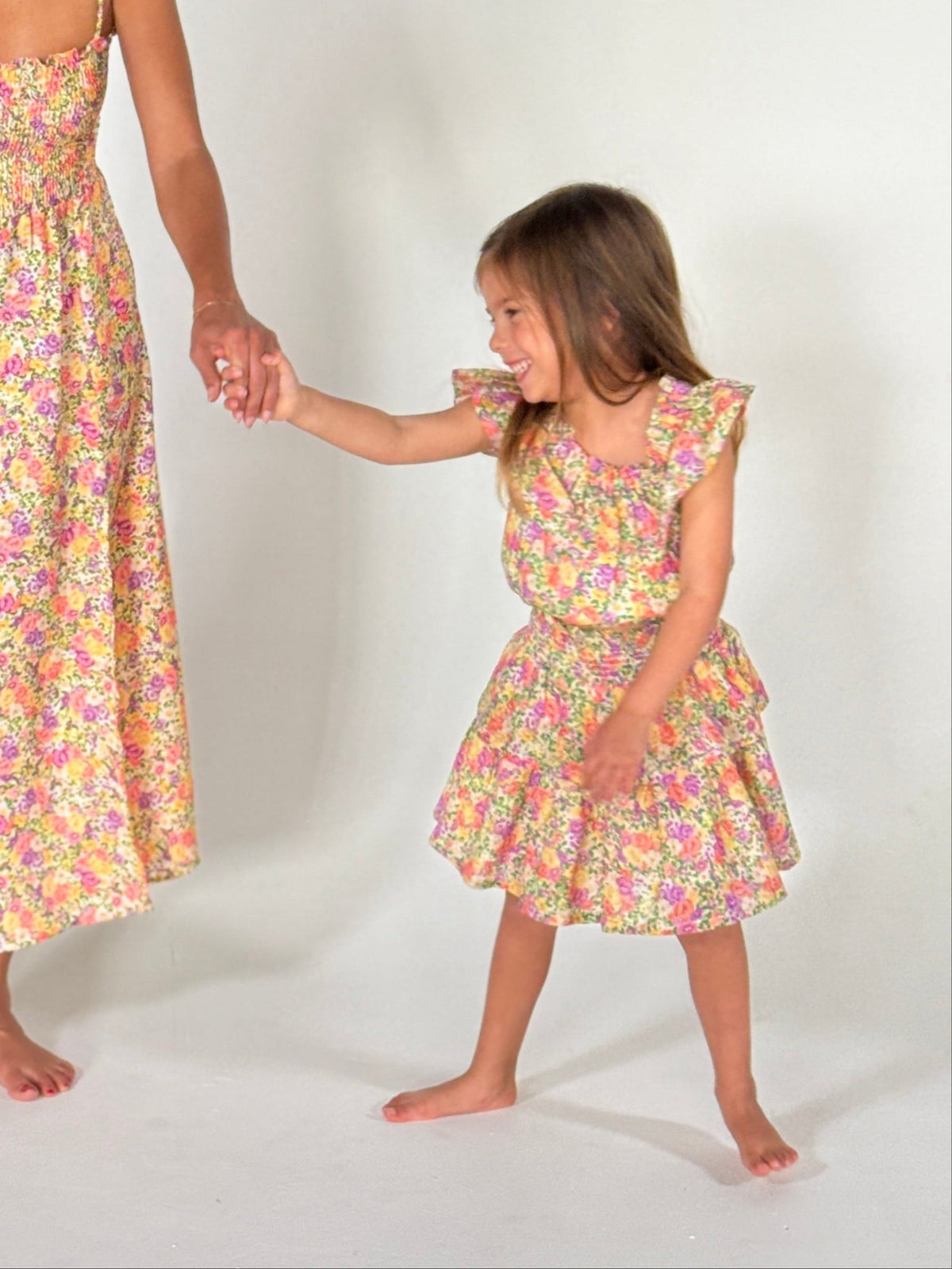 This is an image of Stella Kids Set in April - RESA featuring a model wearing the dress