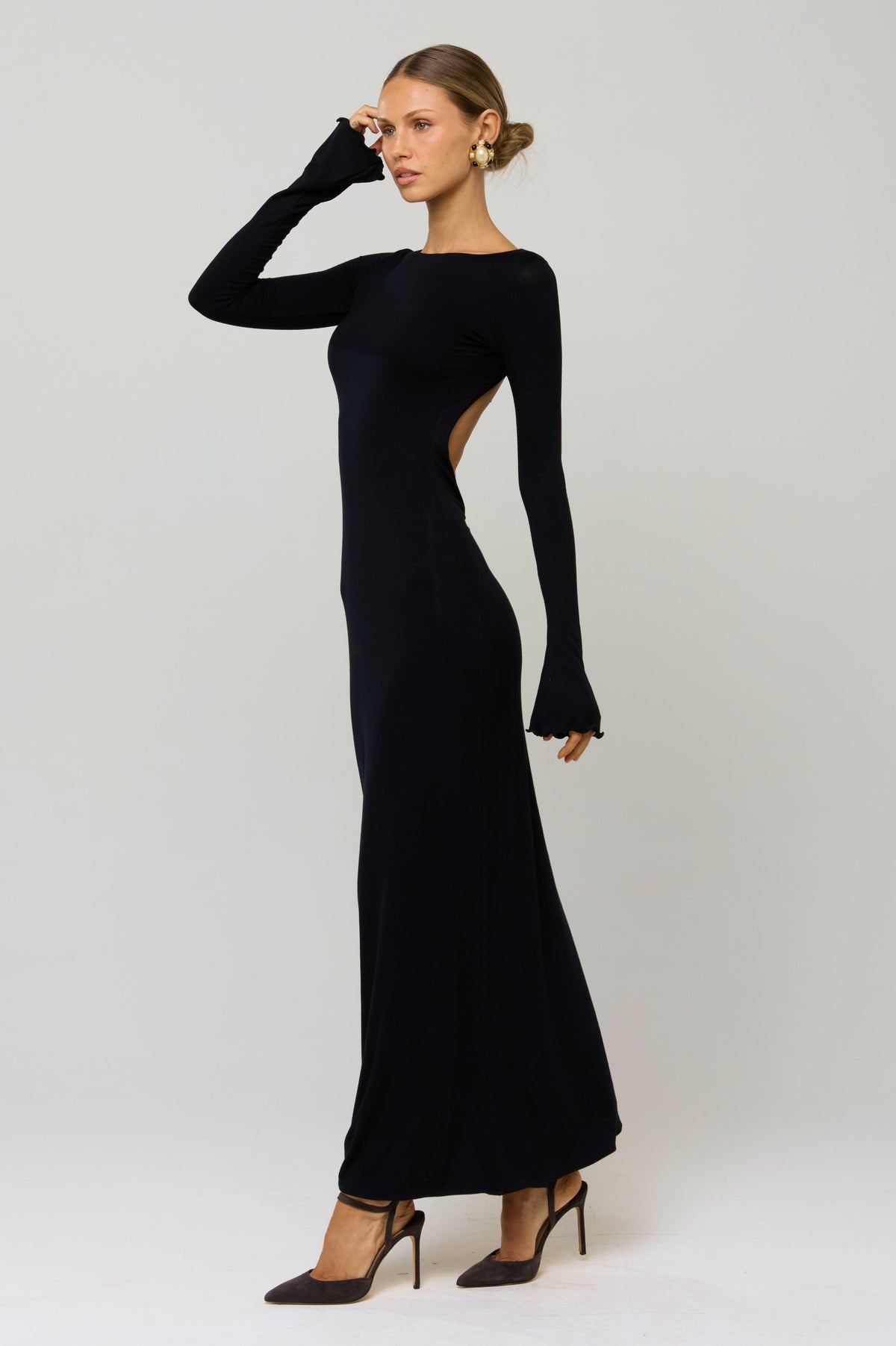 This is an image of Sylvia Dress in Black Knit - RESA featuring a model wearing the dress