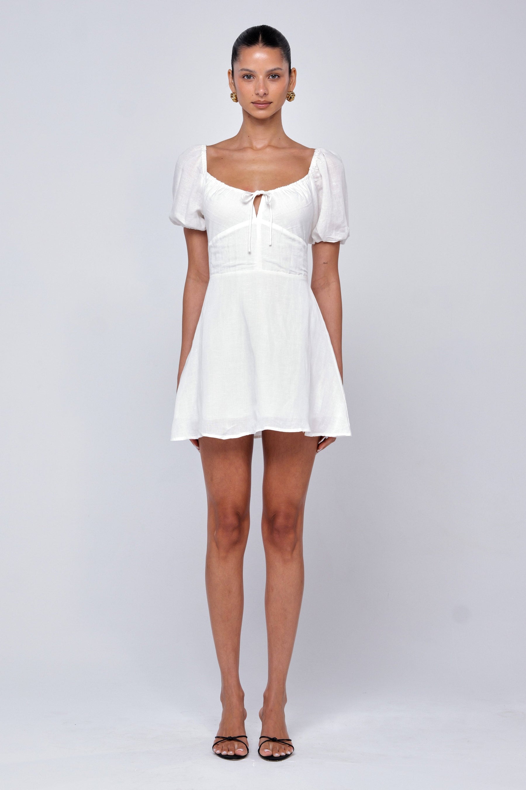 This is an image of Winnie Mini in White Linen - RESA featuring a model wearing the dress