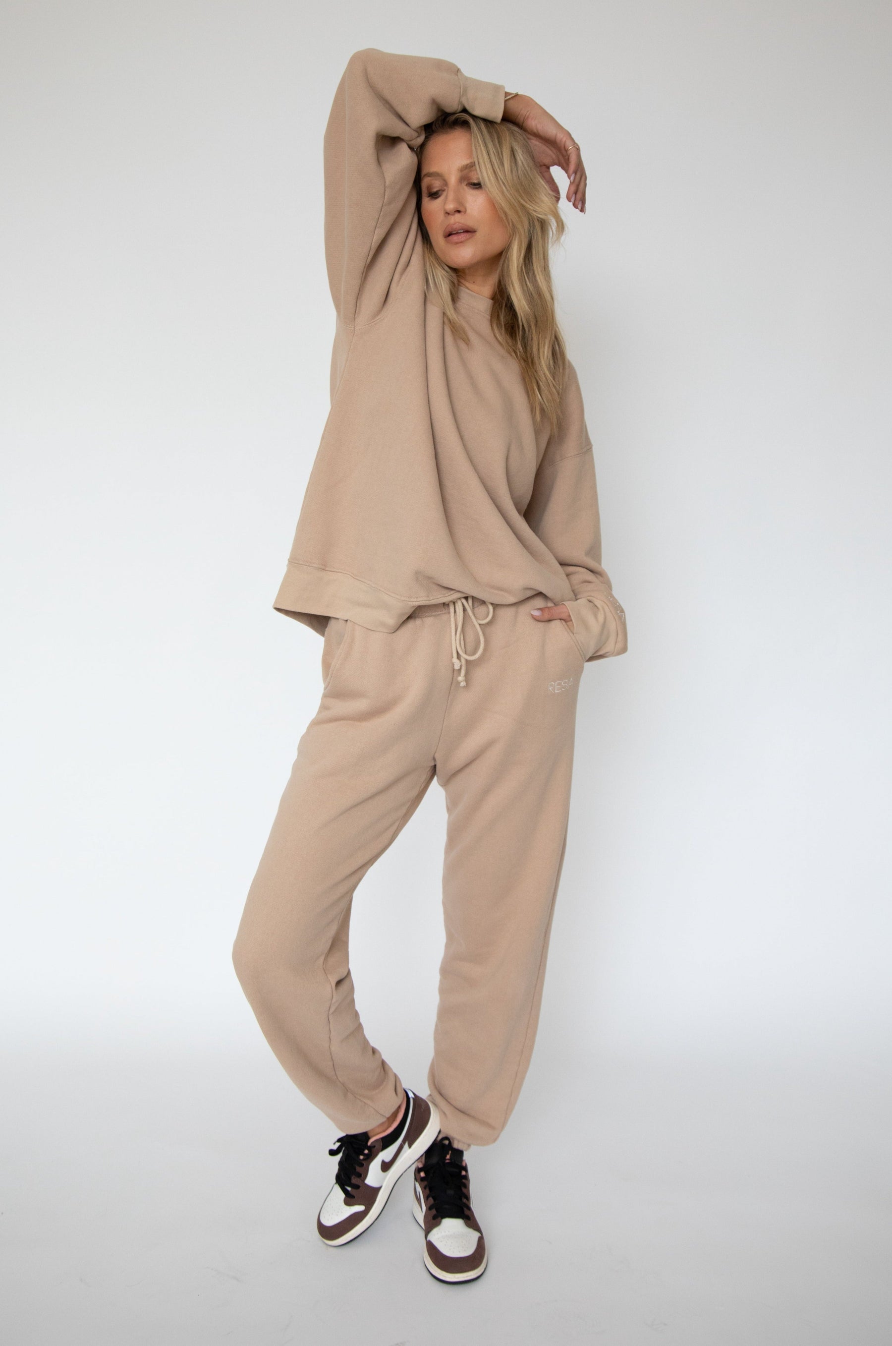 This is an image of Bodhi Sweat pants in Sand - RESA featuring a model wearing the dress