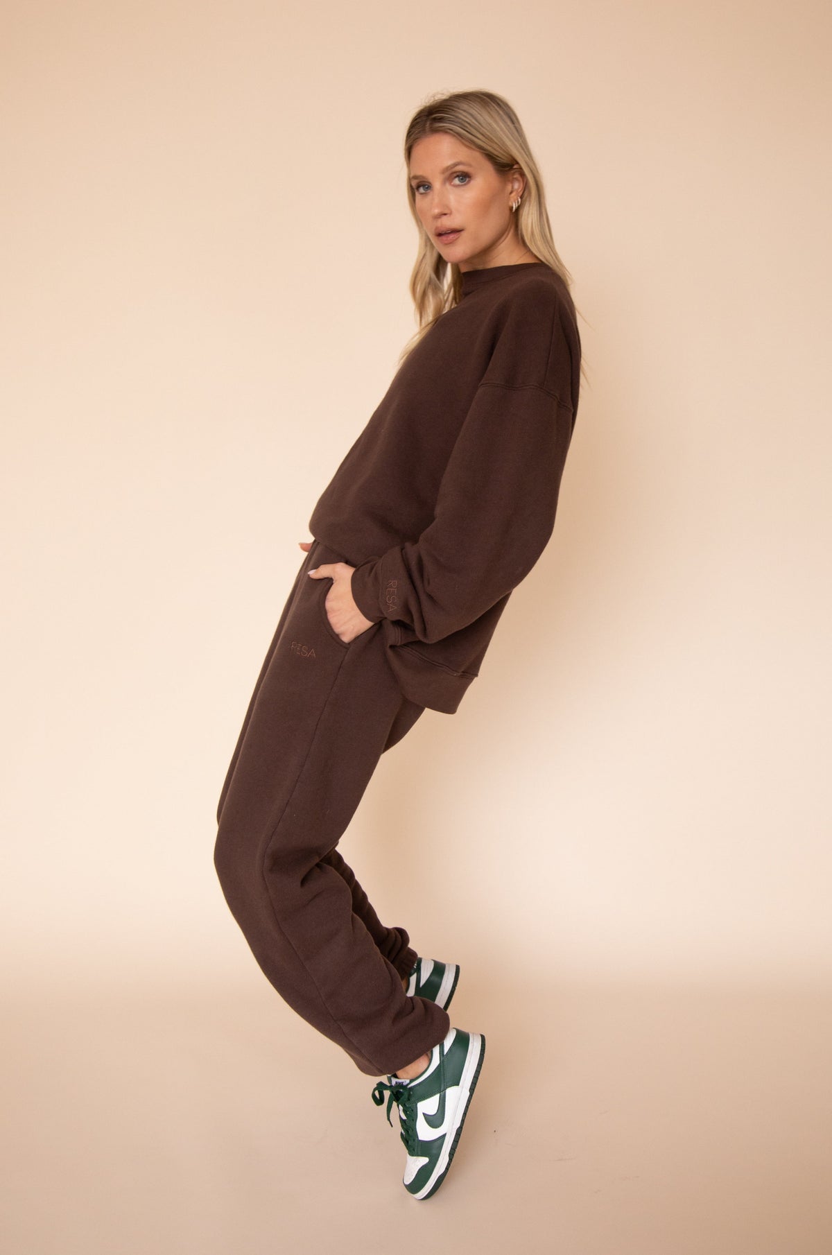 This is an image of Bodhi Sweat pants in Tobacco - RESA featuring a model wearing the dress