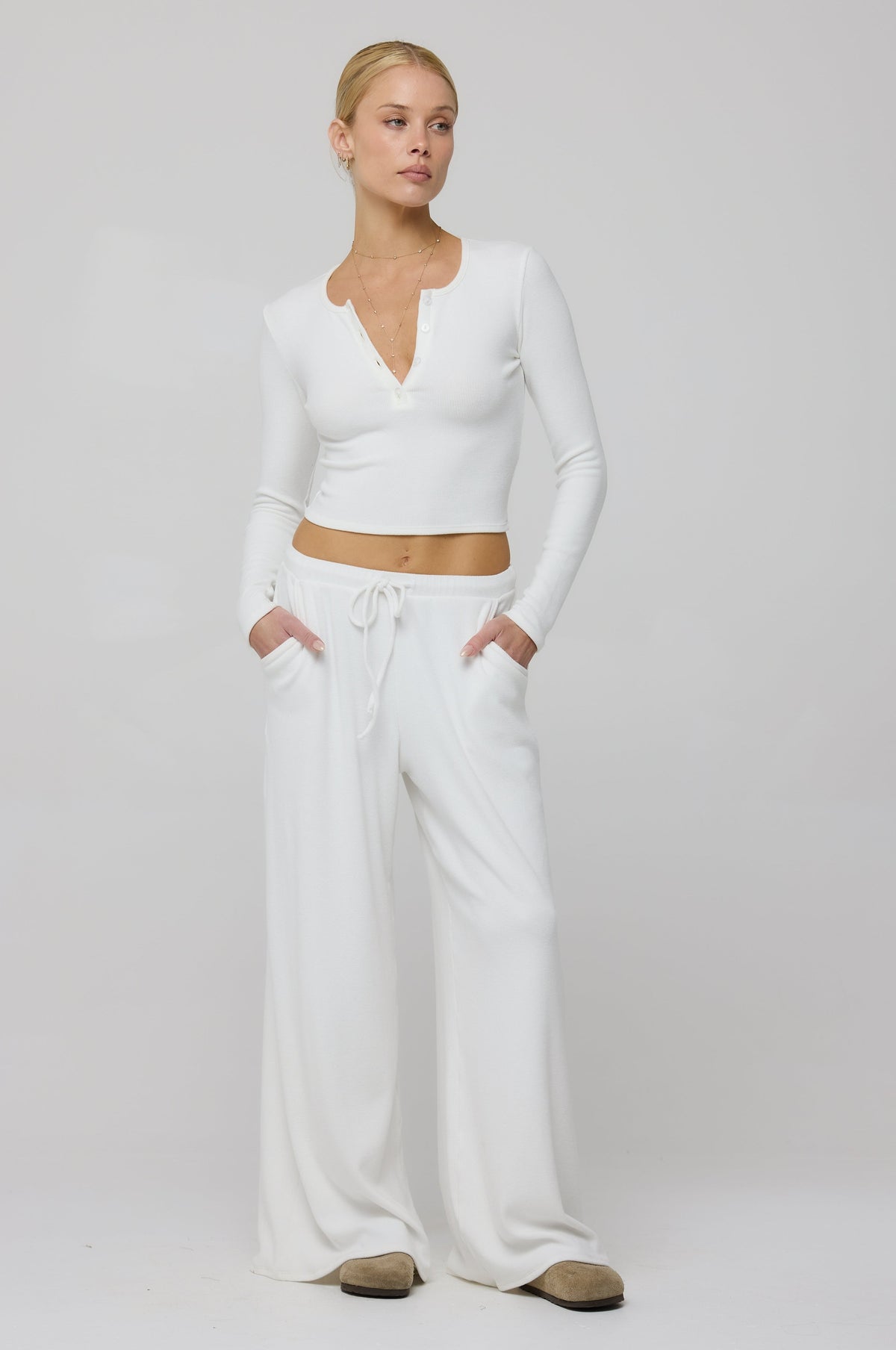 This is an image of Chase Rib Pant in White - RESA featuring a model wearing the dress