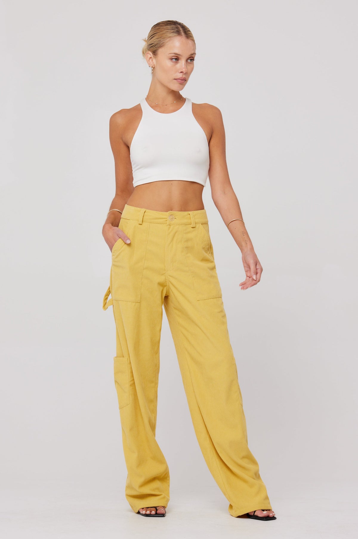 This is an image of Elsa Cargo Pant in Mustard - RESA featuring a model wearing the dress