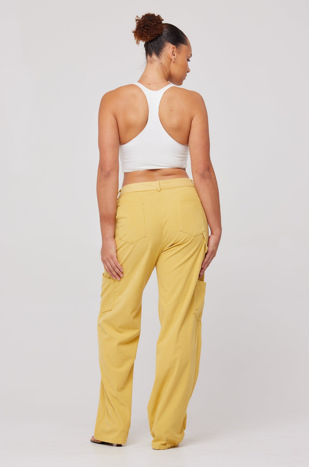 This is an image of Elsa Cargo Pant in Mustard - RESA featuring a model wearing the dress