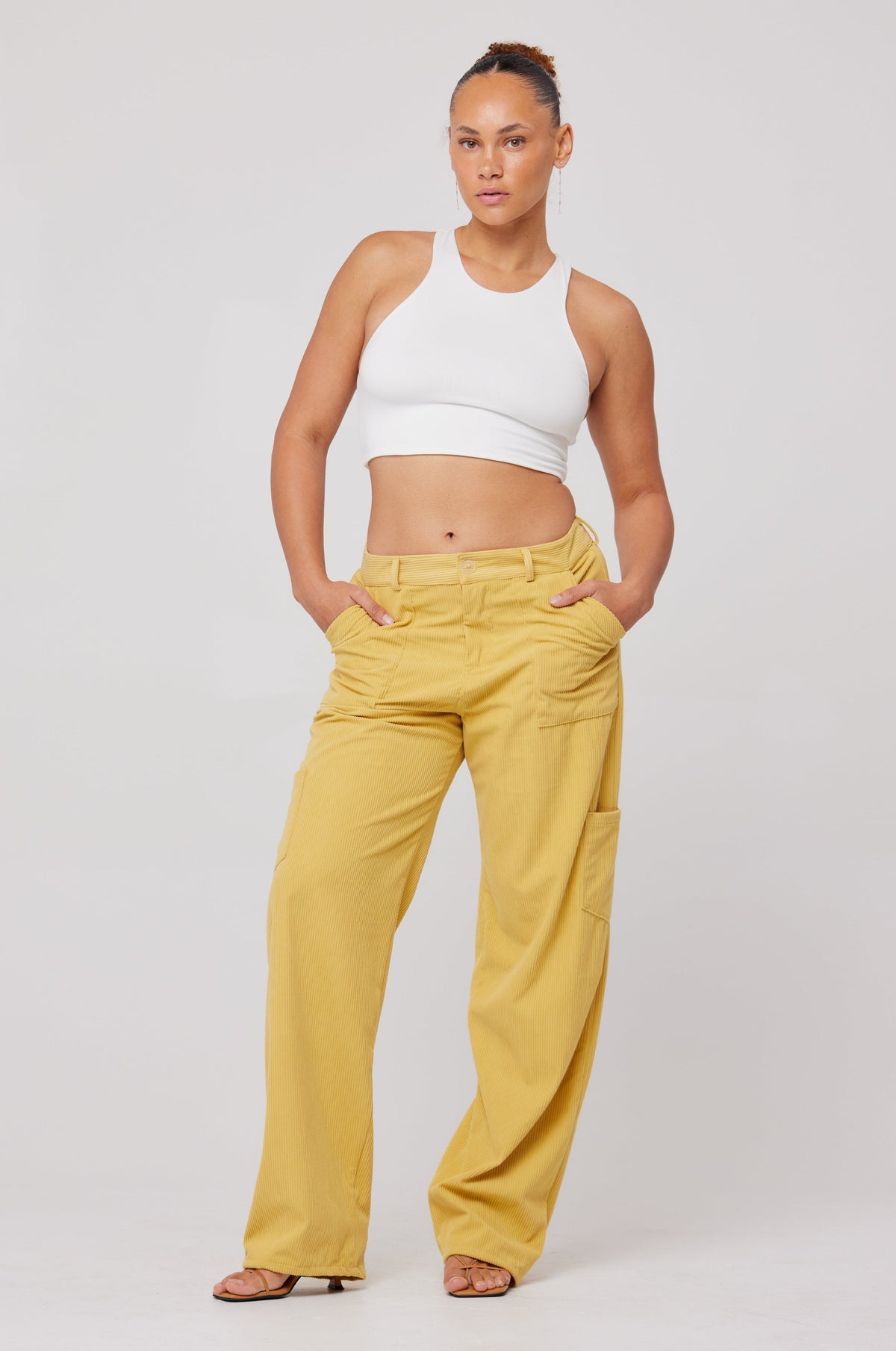 This is an image of Elsa Cargo Pant in Mustard - RESA featuring a model wearing the dress