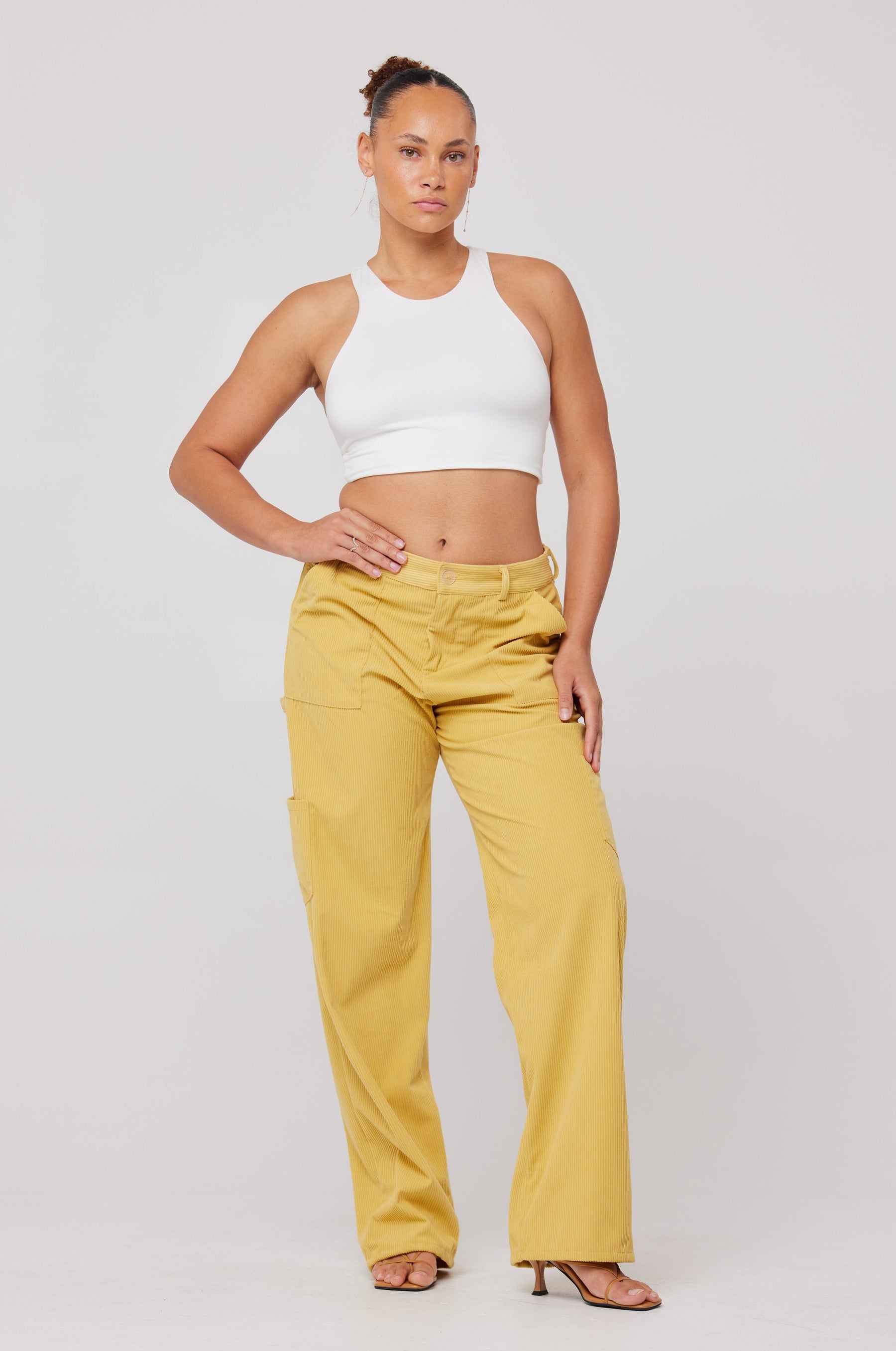 This is an image of Elsa Cargo Pant in Mustard - RESA featuring a model wearing the dress