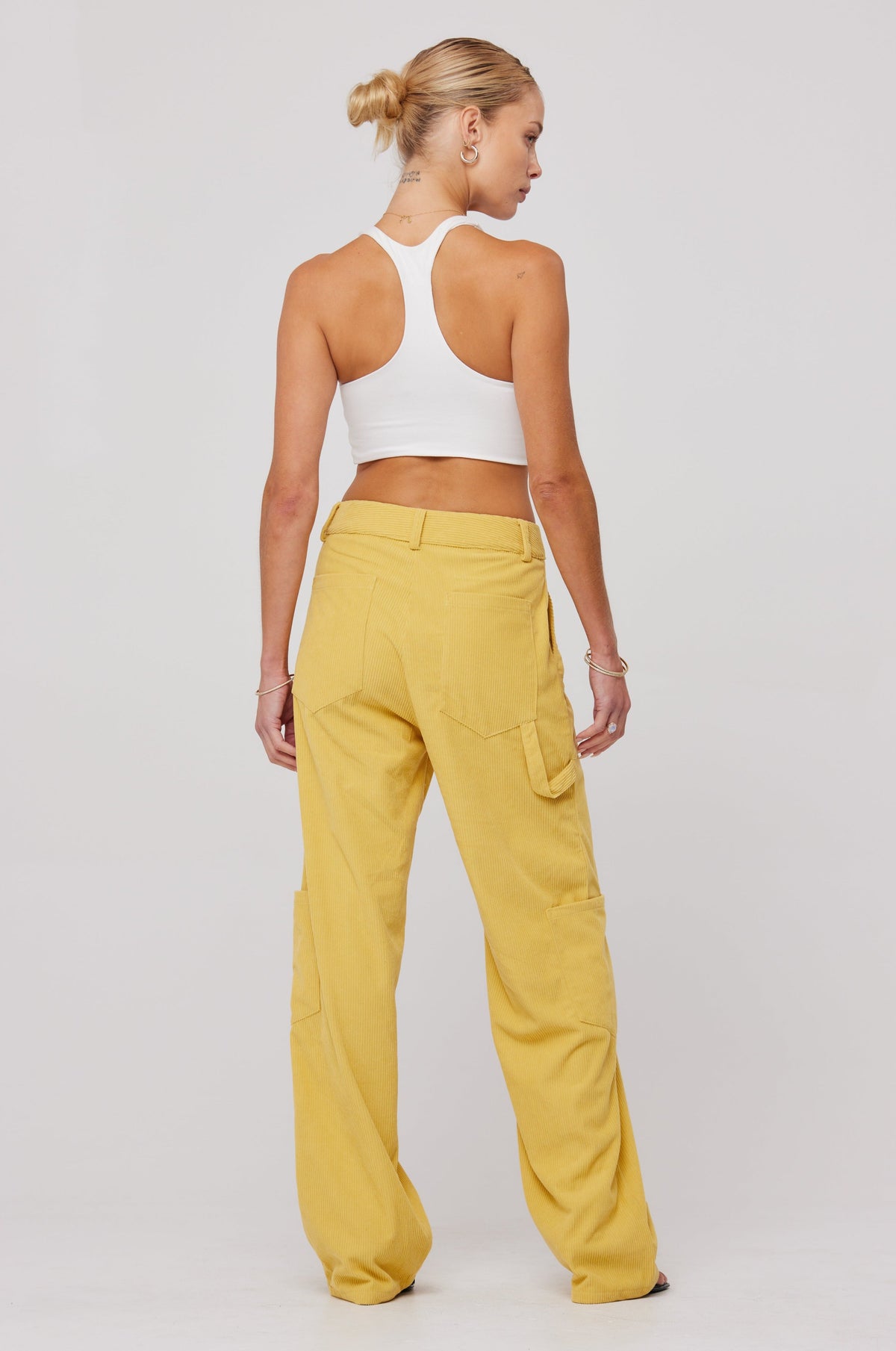 This is an image of Elsa Cargo Pant in Mustard - RESA featuring a model wearing the dress