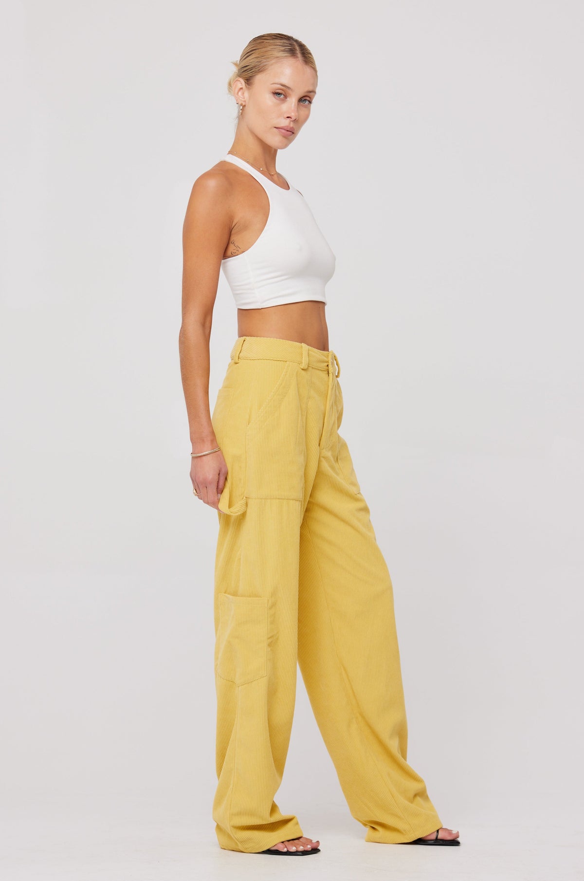 This is an image of Elsa Cargo Pant in Mustard - RESA featuring a model wearing the dress