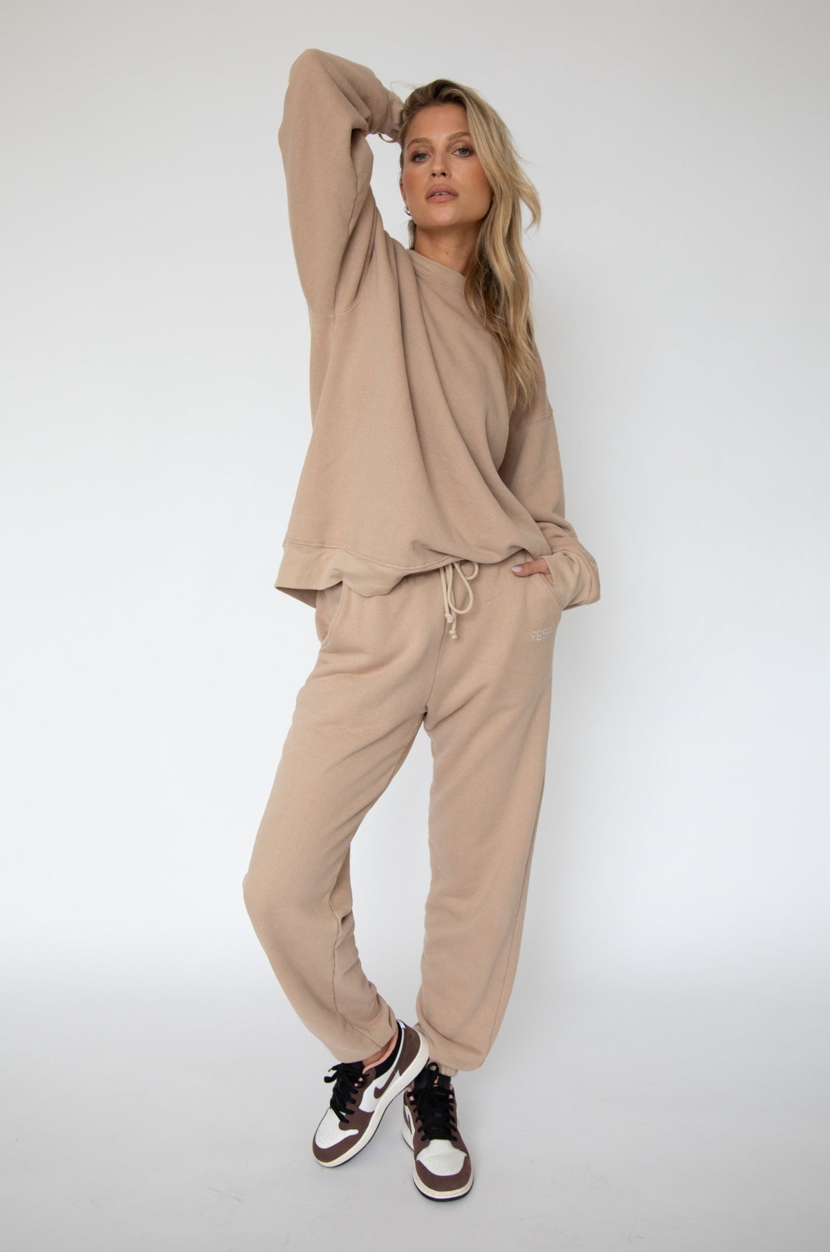 This is an image of Gunner Sweatshirt in Sand - RESA featuring a model wearing the dress