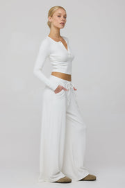 This is an image of Henley Rib in White - RESA featuring a model wearing the dress