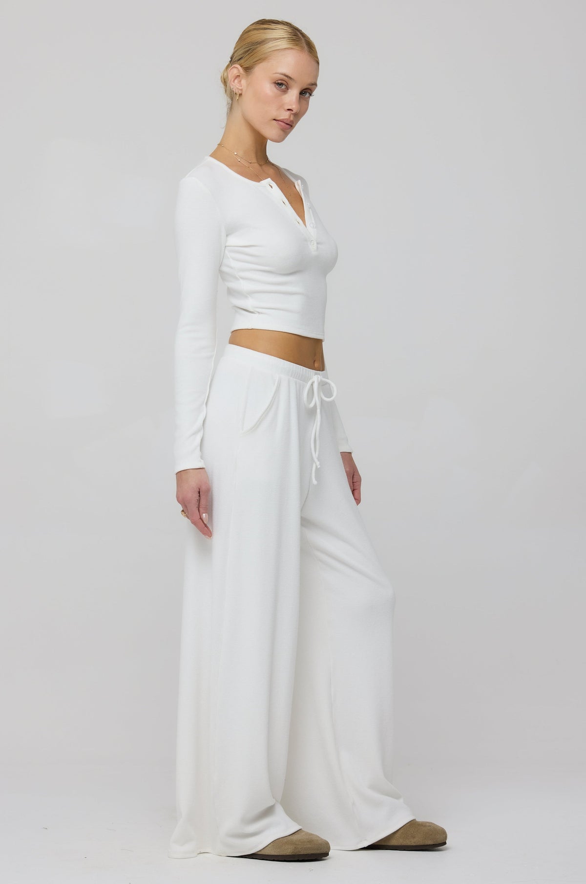 This is an image of Henley Rib in White - RESA featuring a model wearing the dress