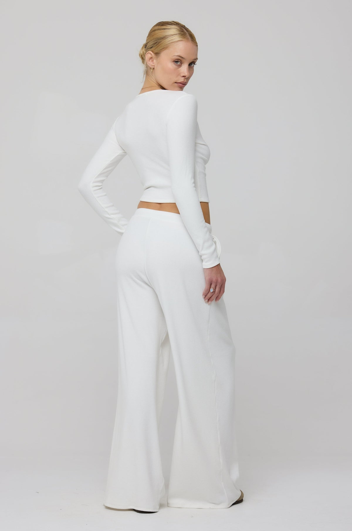 This is an image of Henley Rib in White - RESA featuring a model wearing the dress