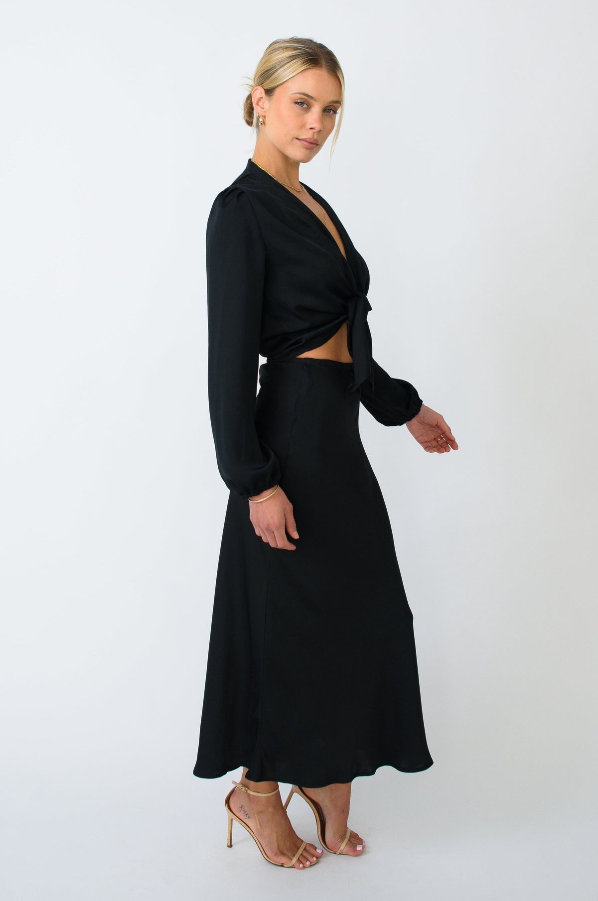 This is an image of Isla Skirt in Black - RESA featuring a model wearing the dress