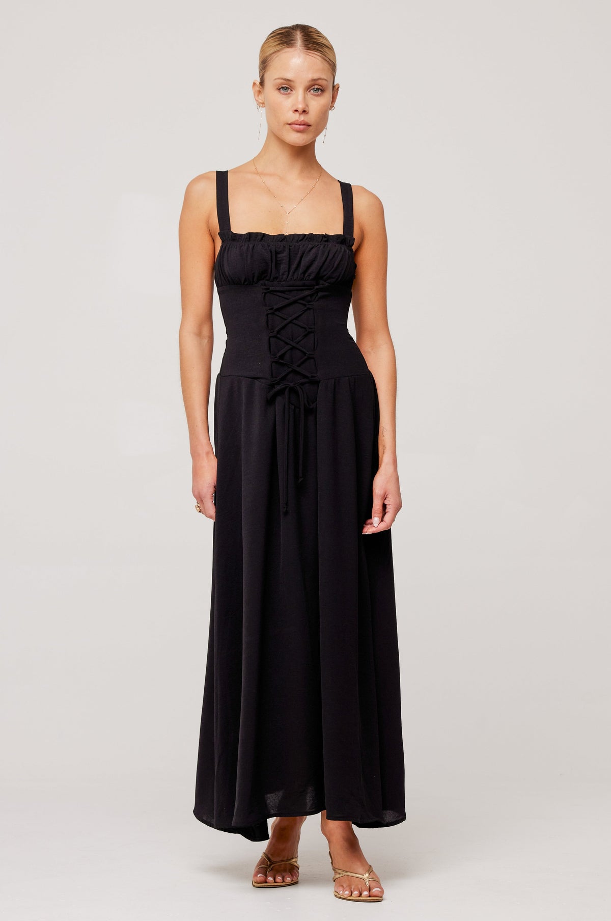 This is an image of Izzy Dress in Black - RESA featuring a model wearing the dress